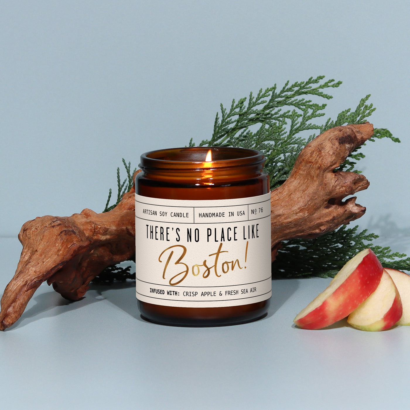 Candle with 'There's No Place Like Boston!' label on a light blue background