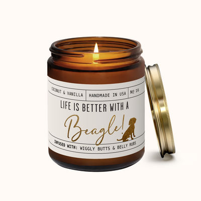 Candle in an amber jar with a label about beagles on a white background