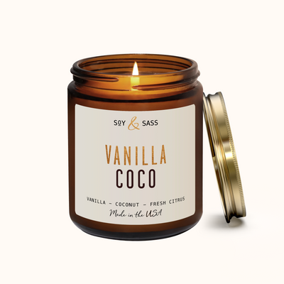 Vanilla Coco candle in an amber jar with a white label on a white background